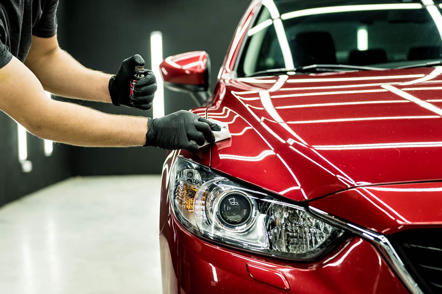 Professional ceramic pro coating application on red car hood in Montrose Colorado for long-lasting shine and paint protection